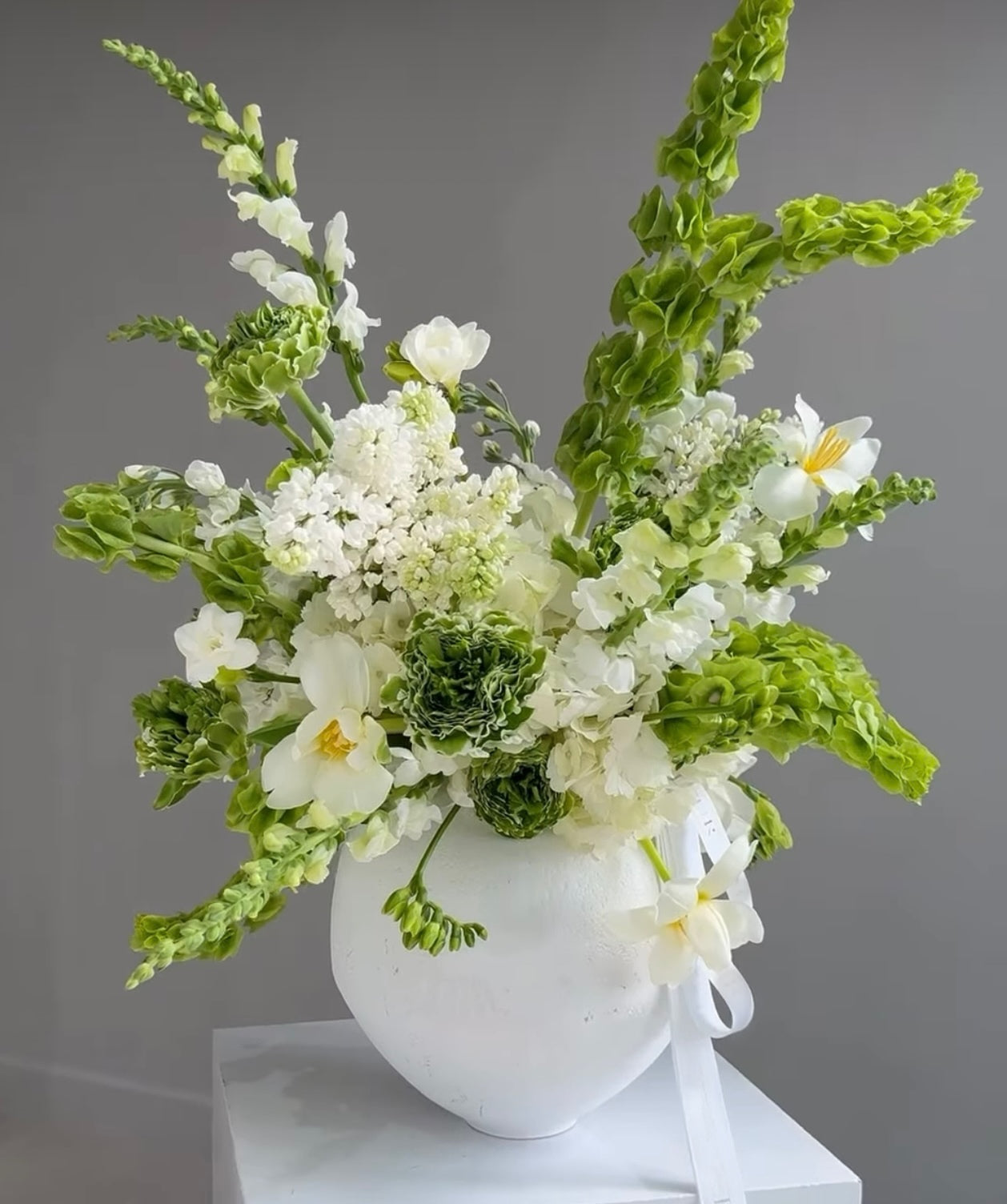 White & Green Arrangement In A Ceramic Vase