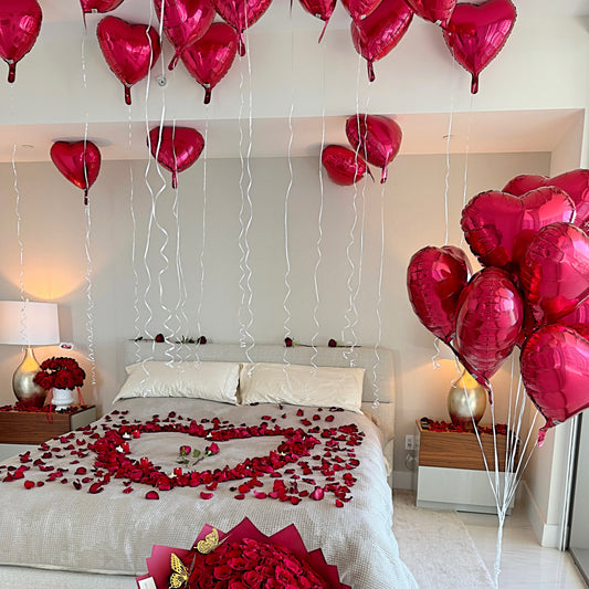 Romantic Decoration Hotel's Room With Red Roses, Petals, Candles, balloons, Wine And Chocolate.